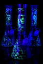 10″ glass beaker bongs with glow-in-the-dark lion graphics, ice pinch and glass-on-glass joints; assorted designs shown.