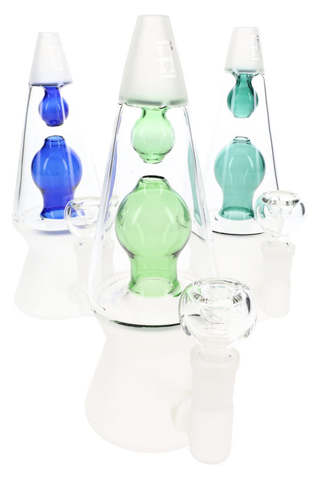 Trio of Hemper That 70’s 7-inch lava lamp glass bongs with blue, teal, and green chambers on frosted white bases, grouped on white.