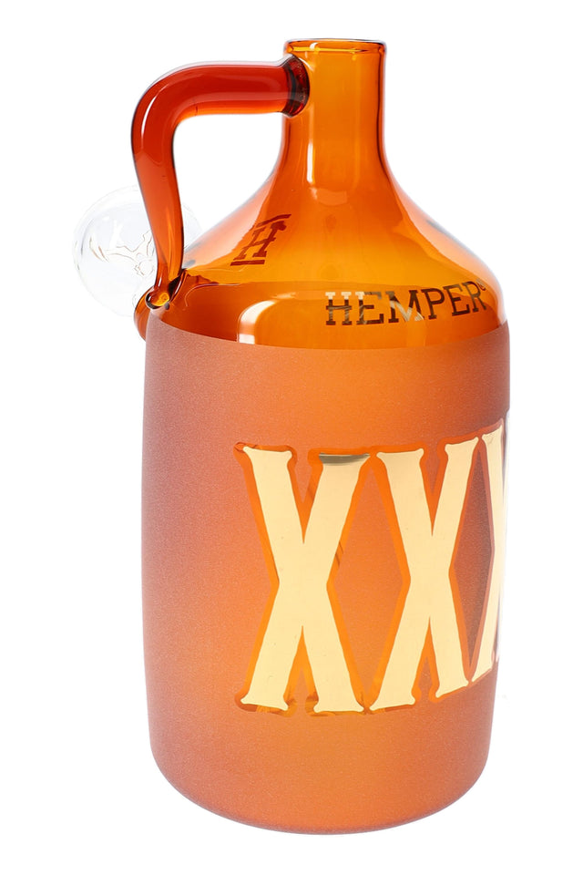Amber moonshine bottle glass bong with frosted XXX lettering and side handle, close studio view highlighting the thick glass body.
