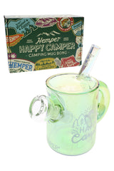 Happy Camper campfire mug bong shown in front of green Hemper camping sticker box, highlighting clear bowl joint and straw-style mouthpiece.