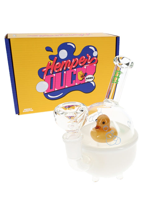 Hemper 6-inch Ducky mini bong displayed in front of bright yellow Ducky Bong box, showing white tub base, bubble dome and matching clear glass bowl.
