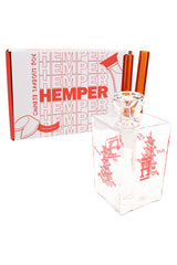 Hemper 6-inch Chinese Takeout Box bong standing beside white and red branded box, showing compact square body and chopstick-style mouthpiece.