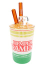 7-inch Hemper ramen cup glass bong with yellow noodle lid, clear bowl and amber chopstick mouthpieces on white.