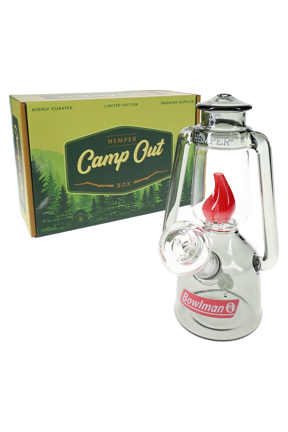 Compact Hemper Bowlman Lantern 7″ glass bong with smoke frame and red flame centerpiece beside green Camp Out box on white background.