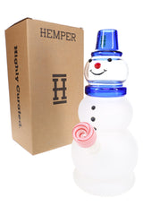 Hemper Snowman XL festive glass bong standing beside brown “Highly Curated” Hemper gift box, showing jolly face and striped bowl.