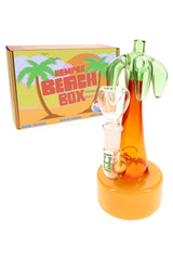 Hemper Palm Tree mini bong standing beside bright Beach Box packaging, showing tropical colors and compact 7-inch design.