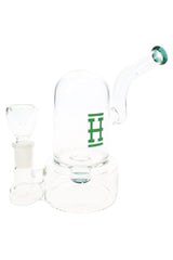 Clear 7-inch Hemper bell glass bong with green logo and bent neck, wide base and matching green-accent bowl on white background.