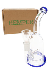 Hemper Whistler 6½ inch glass bong displayed in front of brown Hemper box, showing bent neck, inline perc and included bowl.