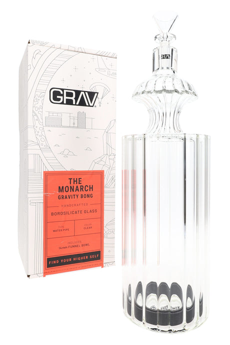 GRAV Monarch clear glass gravity bong beside branded box, with tall fluted body and art deco styling on white backdrop.