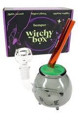 Hemper cauldron glass bong with Witchy Box packaging, glow green bubble top and amber mouthpiece, 6″ tall