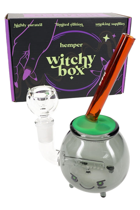 Hemper cauldron glass bong with Witchy Box packaging, glow green bubble top and amber mouthpiece, 6″ tall