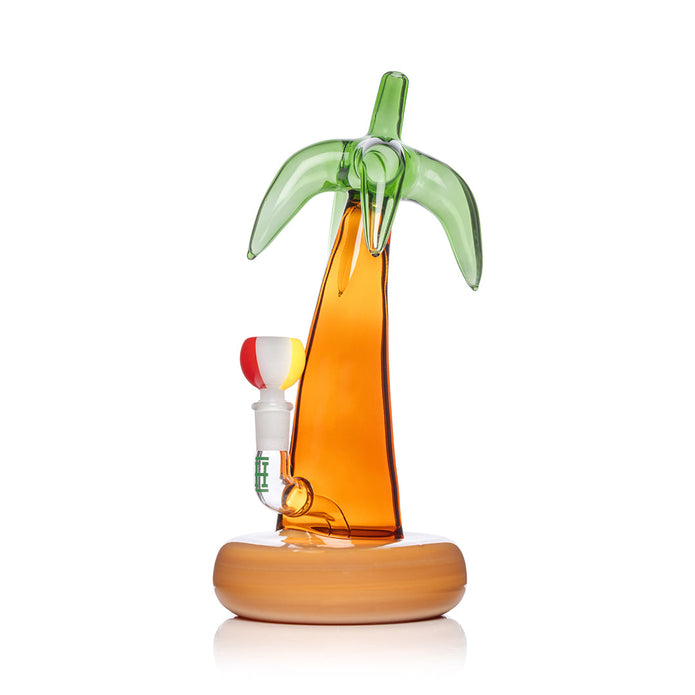 Angled palm tree bong shot showing showerhead perc area through amber trunk and float-style sand base design