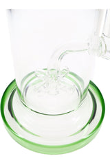 Sprinkler percolator closeup inside glass bong base with green accent ring, angled macro detail shot
