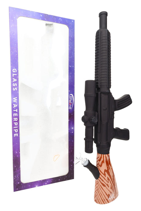 Boxed 24″ rifle-shaped beaker bong beside windowed retail box, oversized novelty glass display piece