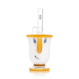 Front view tea cup glass bong showing smiling face, amber rim and base, clear straw mouthpiece with Hemper logo