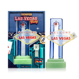 Angled view Las Vegas sign glass bong showing raised sign plaque, blue border, green base, and flower bowl included