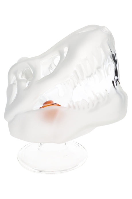 Side view of frosted dinosaur skull glass bong showing sculpted teeth, clear pedestal base, and amber inner accent