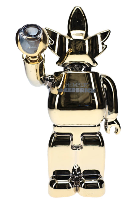 Mirror-gold Hemper Weedbrick XL glass bong holding clear bowl, 10-inch character silhouette with high-shine finish