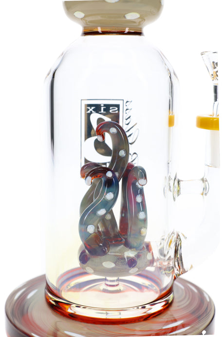 Close-up of silver-fumed bong interior with multicolor tentacle perc accents, clear chamber, and amber details
