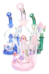 Assorted 10″ glass bongs in pink, blue, and green with inline perc chambers and colorful mushroom accents