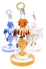 Assorted bee-themed glass bongs in amber, blue, and pink with beehive chambers and colorful drip accents
