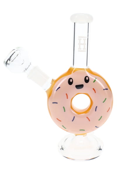 Close-up of donut novelty bong with white mouthpiece, colorful sprinkles, and face decal on yellow body