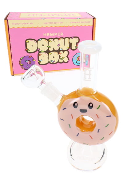 Yellow 6.25-inch donut glass bong with white icing, sprinkle decals, and HEMPER retail box in view