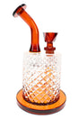 Amber Jane West water pipe angled view with disc mouthpiece, textured body, and warm glass accents