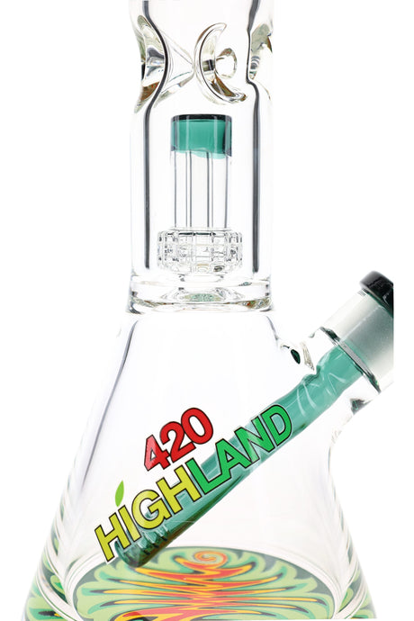 Close-up reverse rasta beaker bong showing dome matrix perc, green downstem, and clear beaker chamber