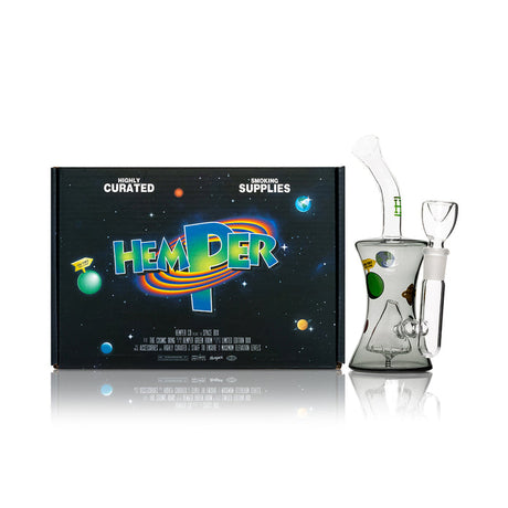 HEMPER Cosmic glass bong beside space-themed box with transparent black body and clear bowl