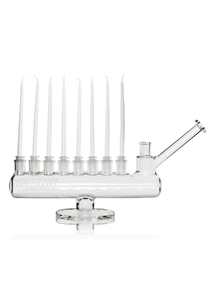GRAV Menorah Bong displayed with eight white taper candles in holders above the clear horizontal chamber.