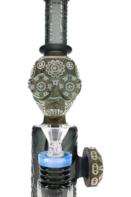Close-up of stone alien glass bong with frosted gear designs, clear bowl, and blue accent ring
