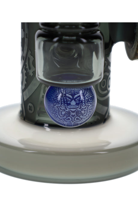 Blue hieroglyphic accent on stone alien glass bong near unique perc and frosted base detail