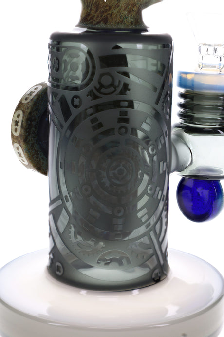 Side view of stone alien glass bong with clear bowl, raised medallion, and etched geometric artwork