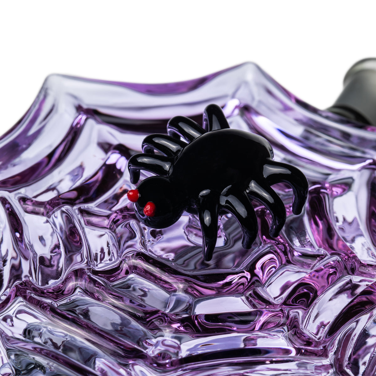 Close-up of black spider accent with red eyes attached to the purple spiderweb body of MJ Arsenal Nightcrawler dab rig