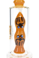 Close-up of 6B Glass bong showing amber sculpted character percolator with black and blue details