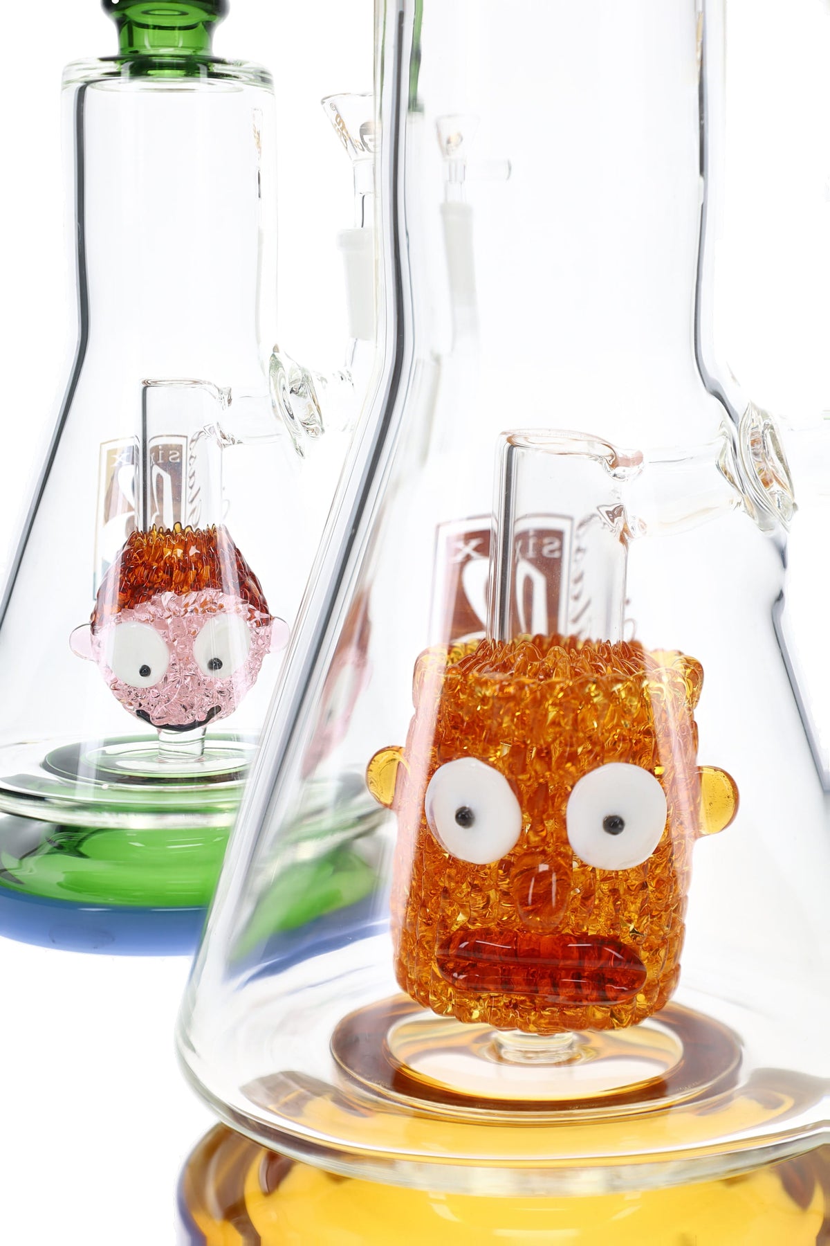 Close-up of 6B Glass bong showing detailed orange and pink sculpted character percolators inside chamber