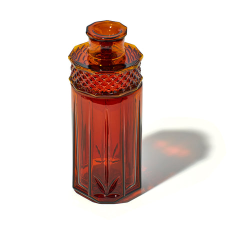 Baltic Amber NWTN Home Highball glass gravity bong viewed at an angle with vintage faceted detailing