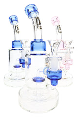 Three clear 6B Glass showerhead perc bongs with curved necks, round bases and blue or pink glass accents.