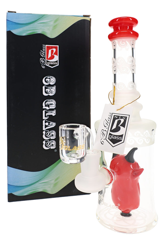 Red-accented 6B Glass frosted demon dab rig with a clear banger and branded hang tag beside its box.