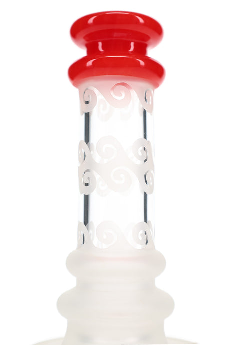 Close-up of a red glass mouthpiece and frosted scroll patterns around the straight neck of a 6B Glass dab rig.