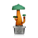 Rear view of Hemper Bonsai XL glass bong with an amber trunk, green canopy and showerhead perc in a dark planter base