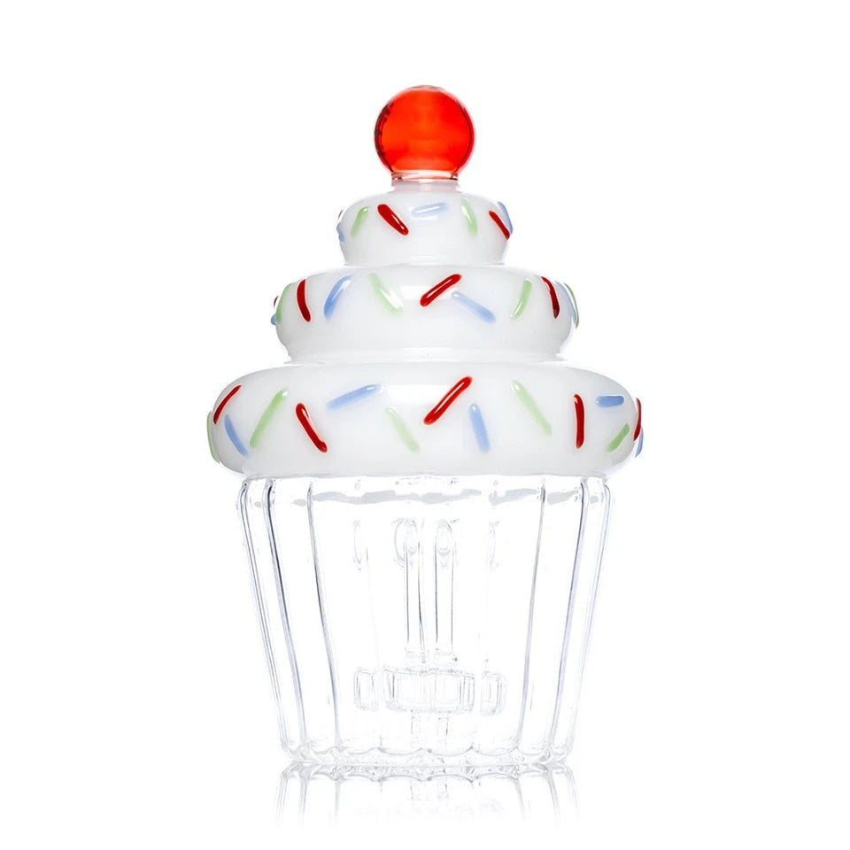 Side view of Hemper Cupcake XL bong showing its red cherry topper, white frosting and clear scalloped base