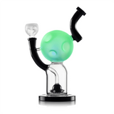 Hemper Moon XL bong showing its moon chamber glowing green above a clear base with a black UFO-shaped perc