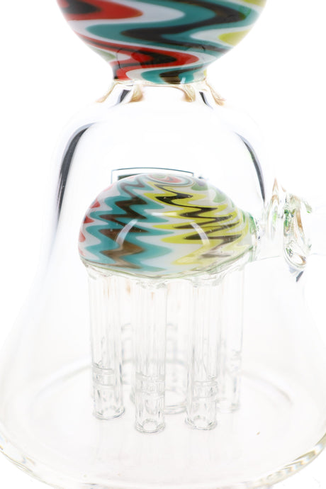 Close-up of reverse tree percolator with clear glass arms beneath a multicolor zigzag-patterned dome.