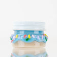 1.5-inch blue donut-style glass terp jar with rainbow sprinkle accents, straight side profile on white background