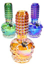 Rainbow metallic 7-inch beaker bong with sculpted skull base, ribbed grip neck, and grommet bowl, shown in three assorted colors on white background.