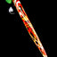 Single green-cap striped mushroom glass dab tool with red, yellow, and white spiral stem, angled on black surface.