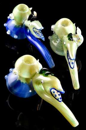 Group of silver-fumed monster hammer bubblers with blue accents and sculpted spikes on a sit-flat base, 8 inches tall.