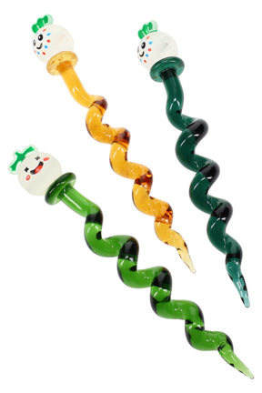 Three 6-inch twisted glass dab tools with smiling veggie toppers and amber, forest-green stems, displayed on white backdrop to show spiral design and colors.